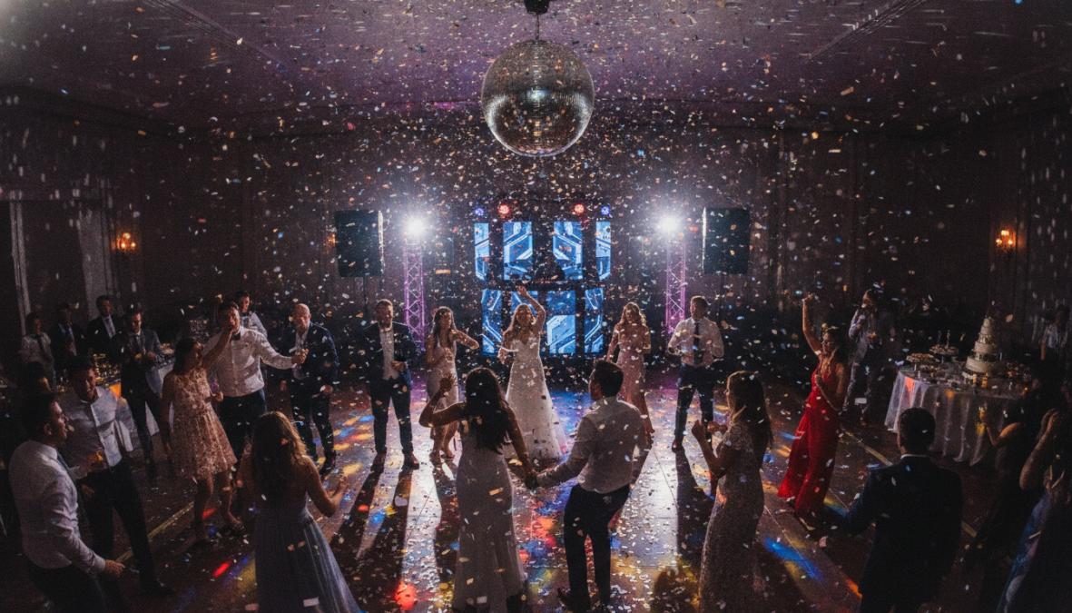 A DJ is Playing Dance Music at a Wedding Party