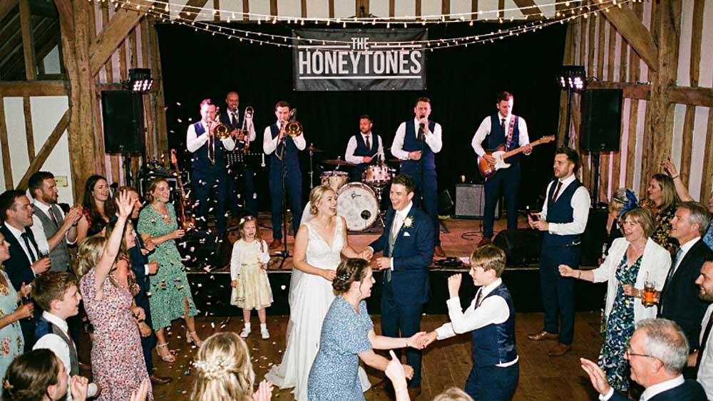 A Wedding Party Band on Stage with Family and Friends Dancing