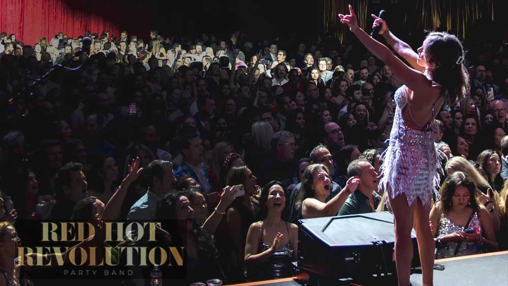 Red Hot Revolution Putting on a High Energy Show for a Large Crowd of Screaming Fans